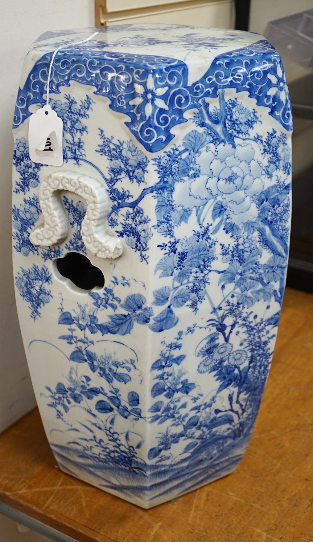 An early 20th century Japanese hexagonal blue and white porcelain garden seat, 50cm high. Condition- fair, has hairline crack